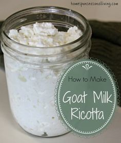 a glass jar filled with goat milk sitting on top of a white counter next to an oven mitt