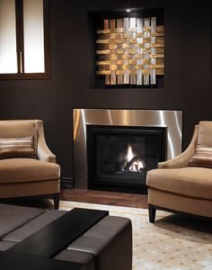 a living room with two chairs and a fire place