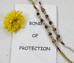 a yellow flower sitting on top of a piece of paper with the words bond of protection