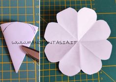 the paper flower is being cut into pieces