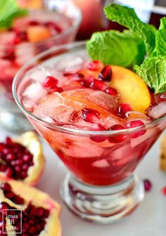 pomegranate and mint garnish in a glass with ice on the side