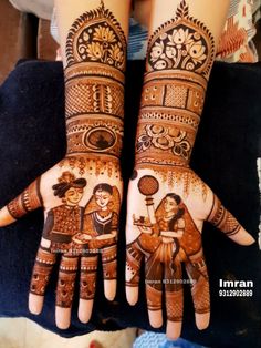 two hands with henna designs on them