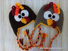 two crocheted turkey hats on top of a wooden table next to each other