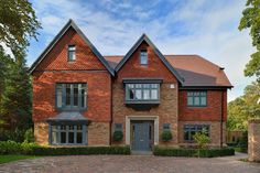 a large brick house with two story windows