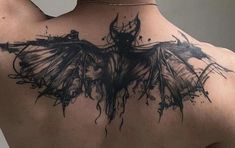 the back of a woman's shoulder with black ink on it