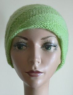 a mannequin head wearing a green knitted hat