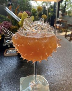 an orange drink sitting on top of a table