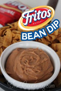 a bowl filled with chips and dip next to a bag of potato chips