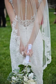 a woman in a wedding dress holding a bouquet