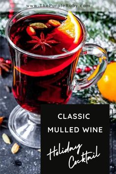 a glass mug filled with mulled wine and topped with an orange slice