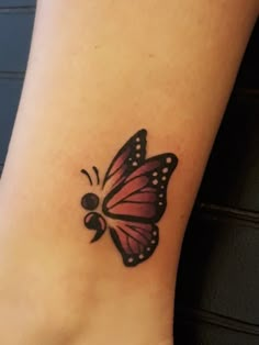 a small butterfly tattoo on the ankle