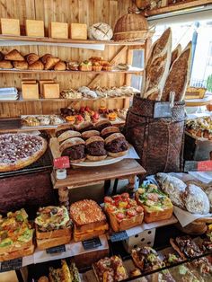 an assortment of breads and pastries on display in a bakery