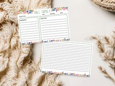 two personalized notepads sitting next to each other on top of a blanket