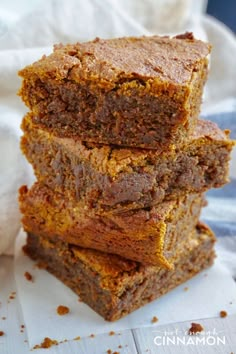 three pieces of brownie stacked on top of each other in front of a white towel