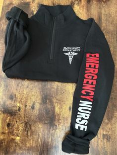 a black sweatshirt with the words emergency nurse on it