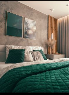 a bed with green comforter and pillows in a bedroom next to a painting on the wall