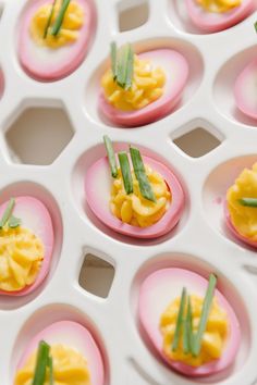 small plates filled with deviled eggs and green onions