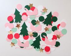 a pile of paper cut outs with christmas trees and ornaments on top of each other