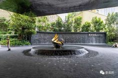 an outdoor fountain in the middle of a park