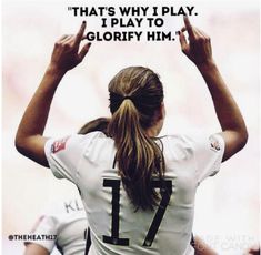 a woman with her hands up in the air while wearing a jersey that says, that's why i play glory him