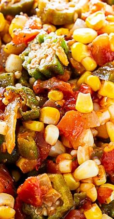 corn and vegetables are mixed together in a bowl with seasoning on top, ready to be eaten