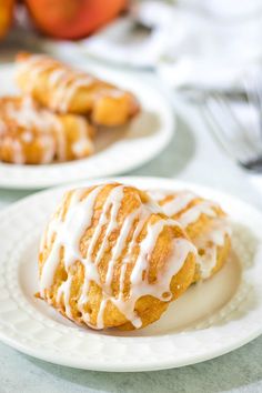 fresh peach fritters with icing on a white plate