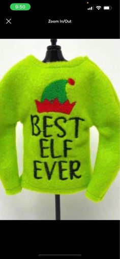 a green sweater with the words best elf ever on it