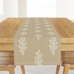 a wooden table topped with a beige table runner