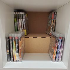 an open cardboard box filled with video game dvds and games on top of each other