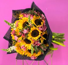 a bouquet of sunflowers and other flowers on a stick