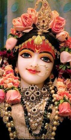 a close up of a statue of a person wearing a costume and flowers on her head