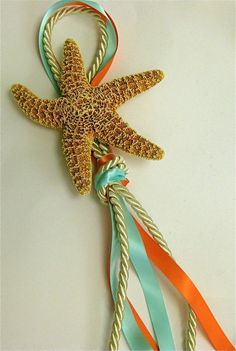 a starfish and some colorful streamers on a white surface