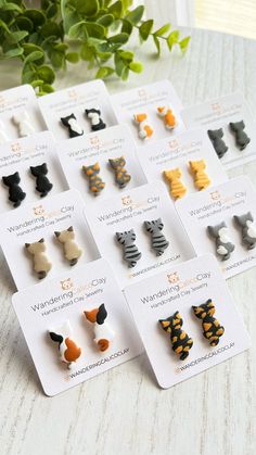 several pairs of cat ear clips are displayed on a table next to a potted plant