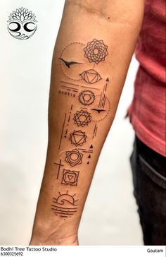 a person with a tattoo on their arm that has different symbols and shapes in it