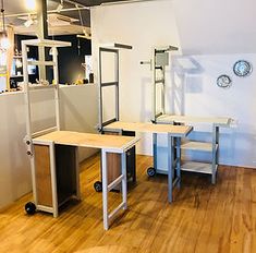 an empty room with two desks and shelves on the wall next to each other