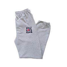 🛒Our unisex retro Self Love Club Sweatpants are a great addition to your closet. The preppy jogging pants are stylish and fashionable, perfect for any outfit. The elastic drawstring waistband will ensure that they fit perfectly, while the comfort and style make them an absolute necessity. 📦 FREE SHIPPING on orders $35 or more to US shoppers 👕Brand = Gildan 🧵Fabric = 50% Cotton / 50% Polyester ✂️Design = Black & Red heat-applied vinyl 🎨Color = Sports Grey (Colors will vary from computer to c Retro Bottoms With Elastic Waistband For Loungewear, Retro Loungewear Pants With Elastic Waistband, Retro Loungewear Bottoms With Elastic Waistband, Retro Letter Print Bottoms For Streetwear, Retro Bottoms With Letter Print For Streetwear, Retro Streetwear Bottoms With Letter Print, Retro Relaxed Fit Loungewear Bottoms, Retro Cotton Loungewear Bottoms, Retro Relaxed Loungewear Bottoms