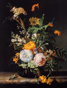 a vase filled with lots of flowers on top of a table