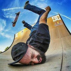 a skateboarder doing a trick on the side of a ramp with his feet in the air