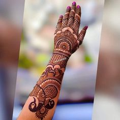 a woman's hand with henna on it