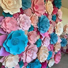 large paper flowers are arranged on the wall