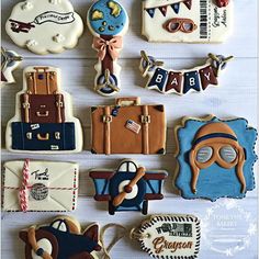 decorated cookies are arranged in the shape of suitcases, luggage and people's names