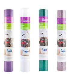 three rolls of purple, green and white glitter paper