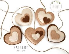 four heart shaped ornaments hanging from a string on a white background with text overlay that says pattern poppy's sv