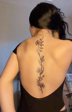 the back of a woman's body with flowers on it