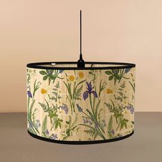 a lampshade with a floral print on the bottom and black trim around it