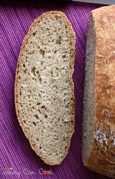 two loaves of bread sitting on top of a purple cloth