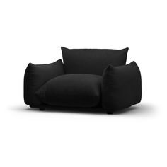 a black couch sitting on top of a white floor next to two pillow pillows in front of it