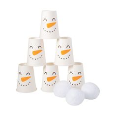 a group of snowman cups sitting next to each other on top of white balls