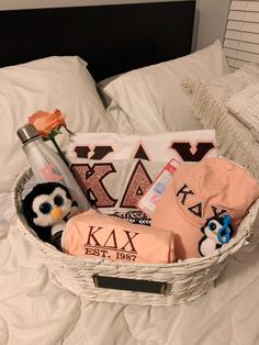 a white basket filled with personal items on top of a bed next to a pillow