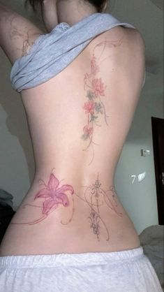 a woman's back with flowers on it